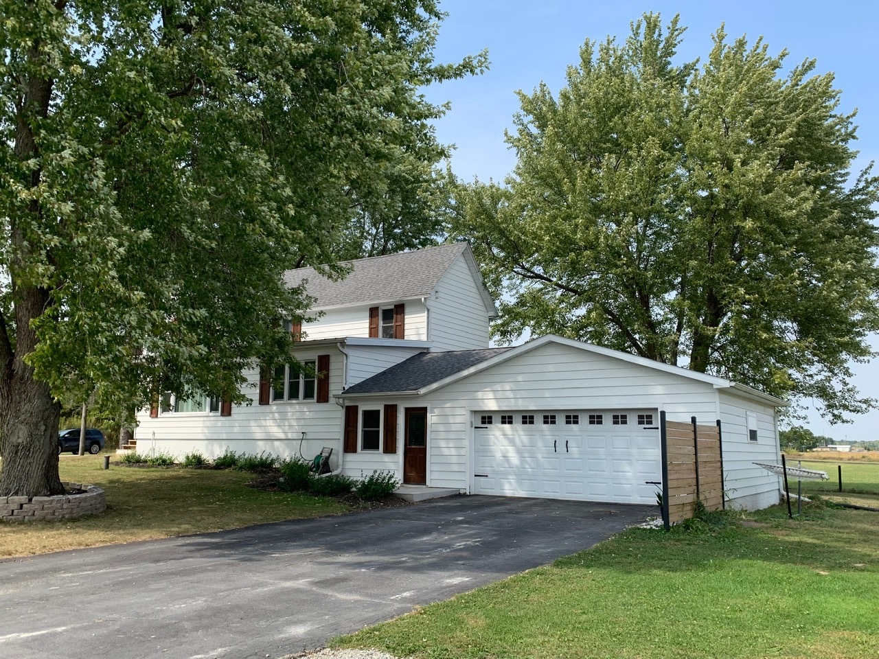13920 Crosby Road Morrison, IL 61270 - Photo 2 of 30 a front view of a house with a garden and trees