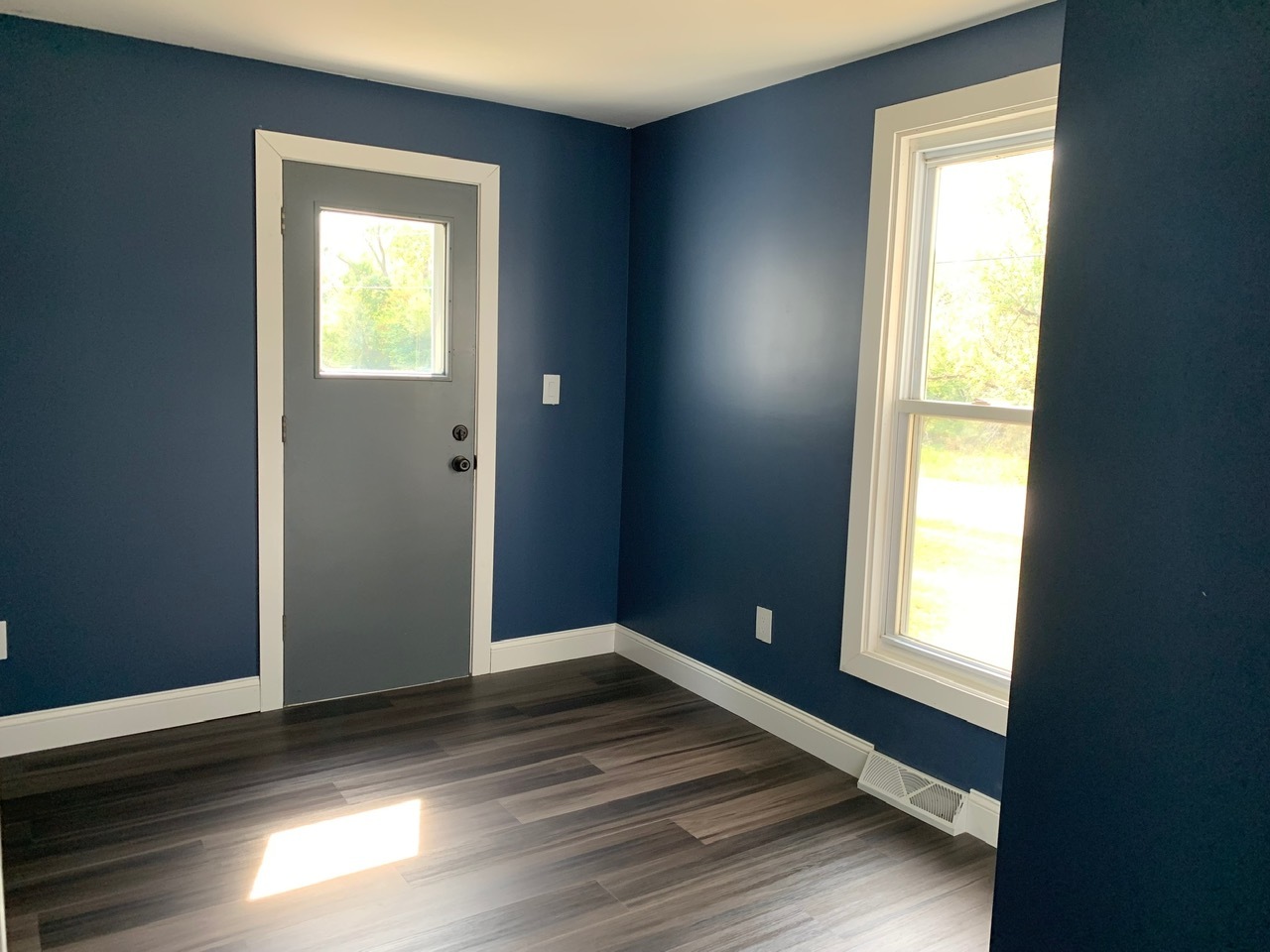 13920 Crosby Road Morrison, IL 61270 - Photo 12 of 30 a view of an empty room with wooden floor and a window