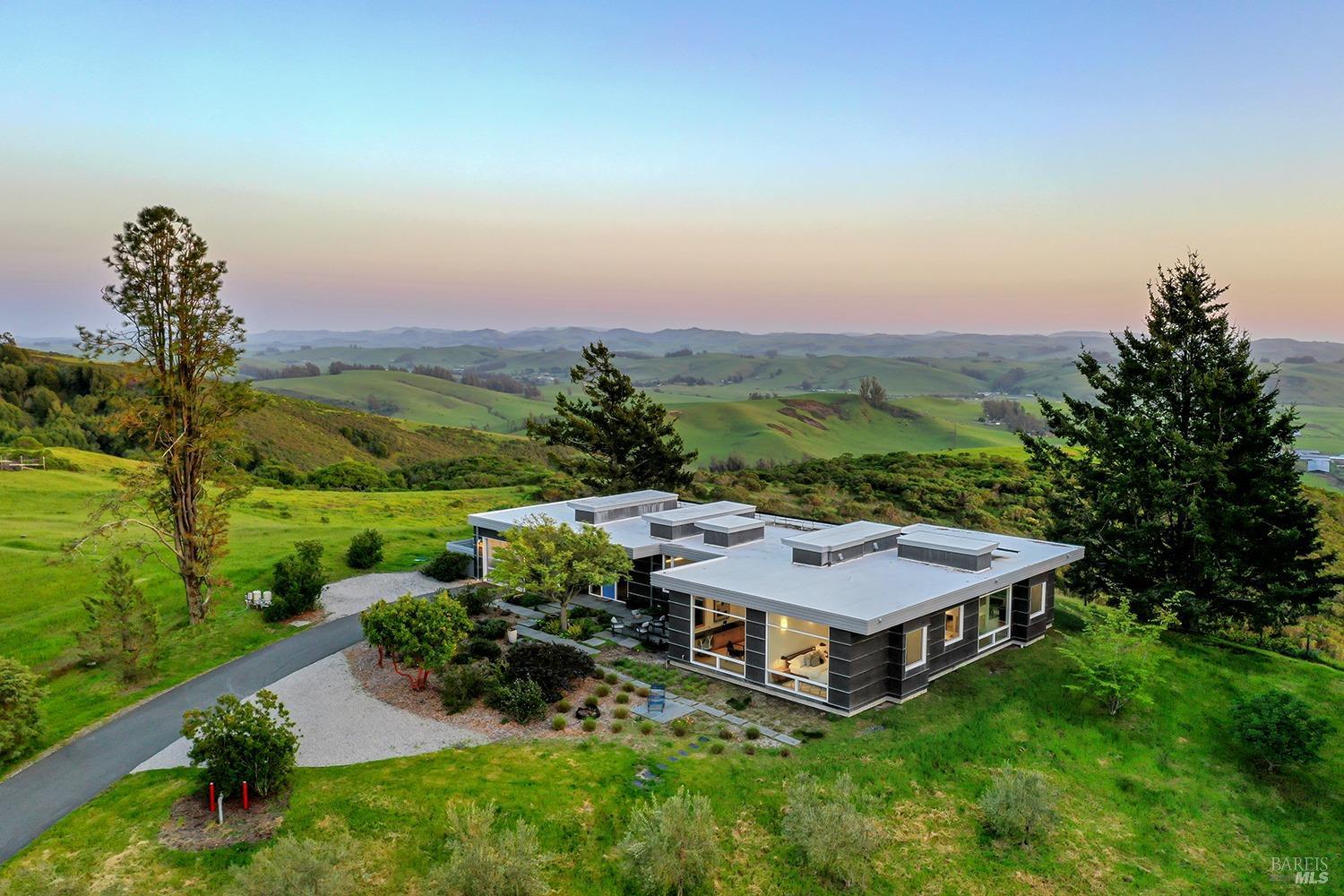 a view of a house with a garden and a yard