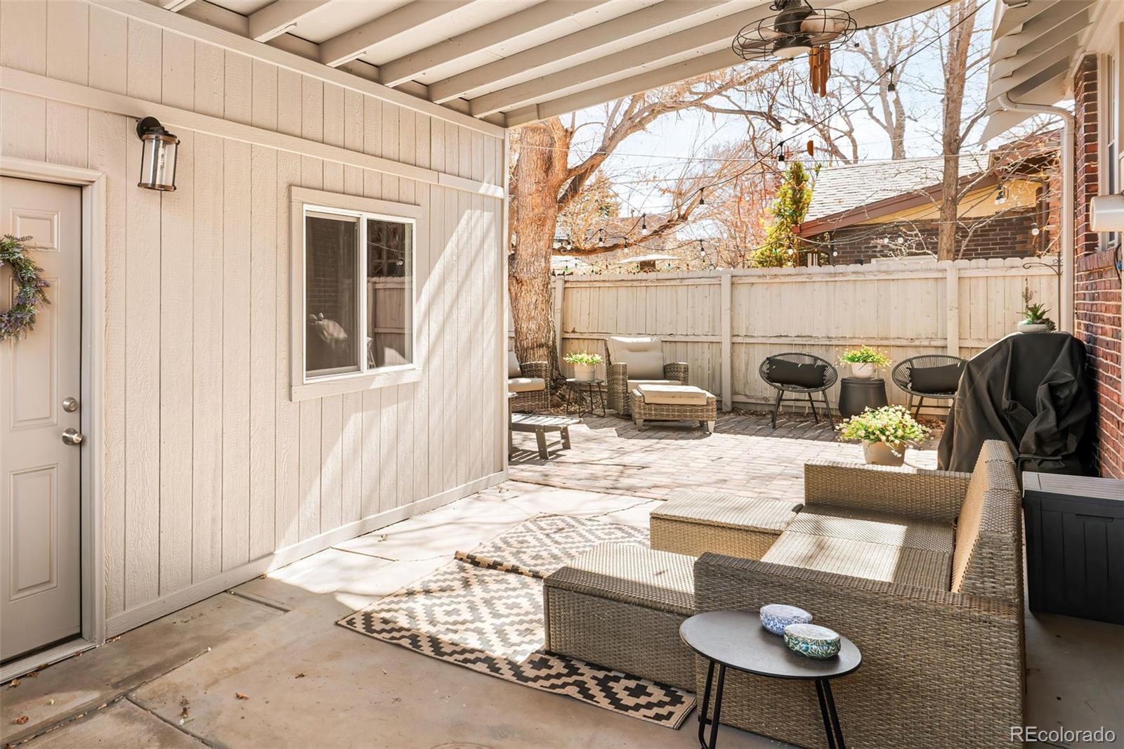 910 Steele Street Denver, CO 80206 - Photo 29 of 33 a view of a patio with couches chairs and potted plants