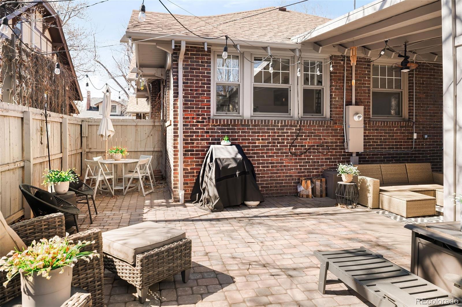 910 Steele Street Denver, CO 80206 - Photo 31 of 33 a view of a patio with couches table and chairs and potted plants