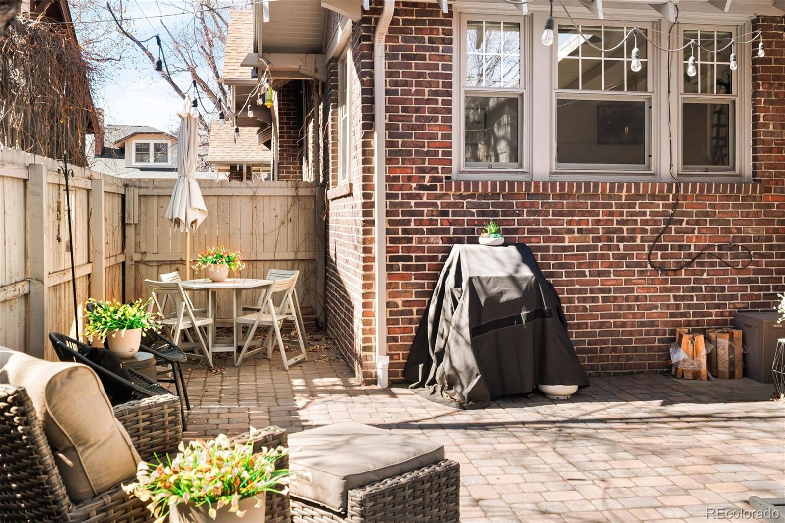 910 Steele Street Denver, CO 80206 - Photo 32 of 33 a view of a patio with couple of chairs and a fountain