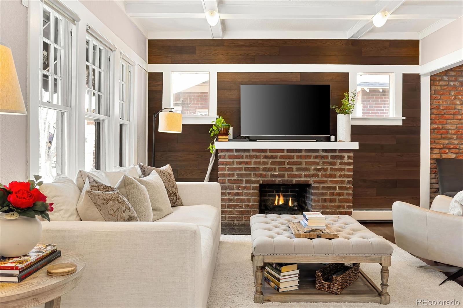 910 Steele Street Denver, CO 80206 - Photo 7 of 33 a living room with furniture a flat screen tv and a fireplace