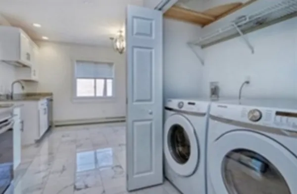 a utility room with sink dryer and washer