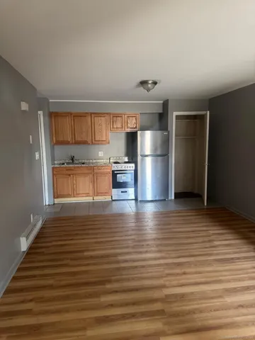 a view of a kitchen with a sink and a refrigerator