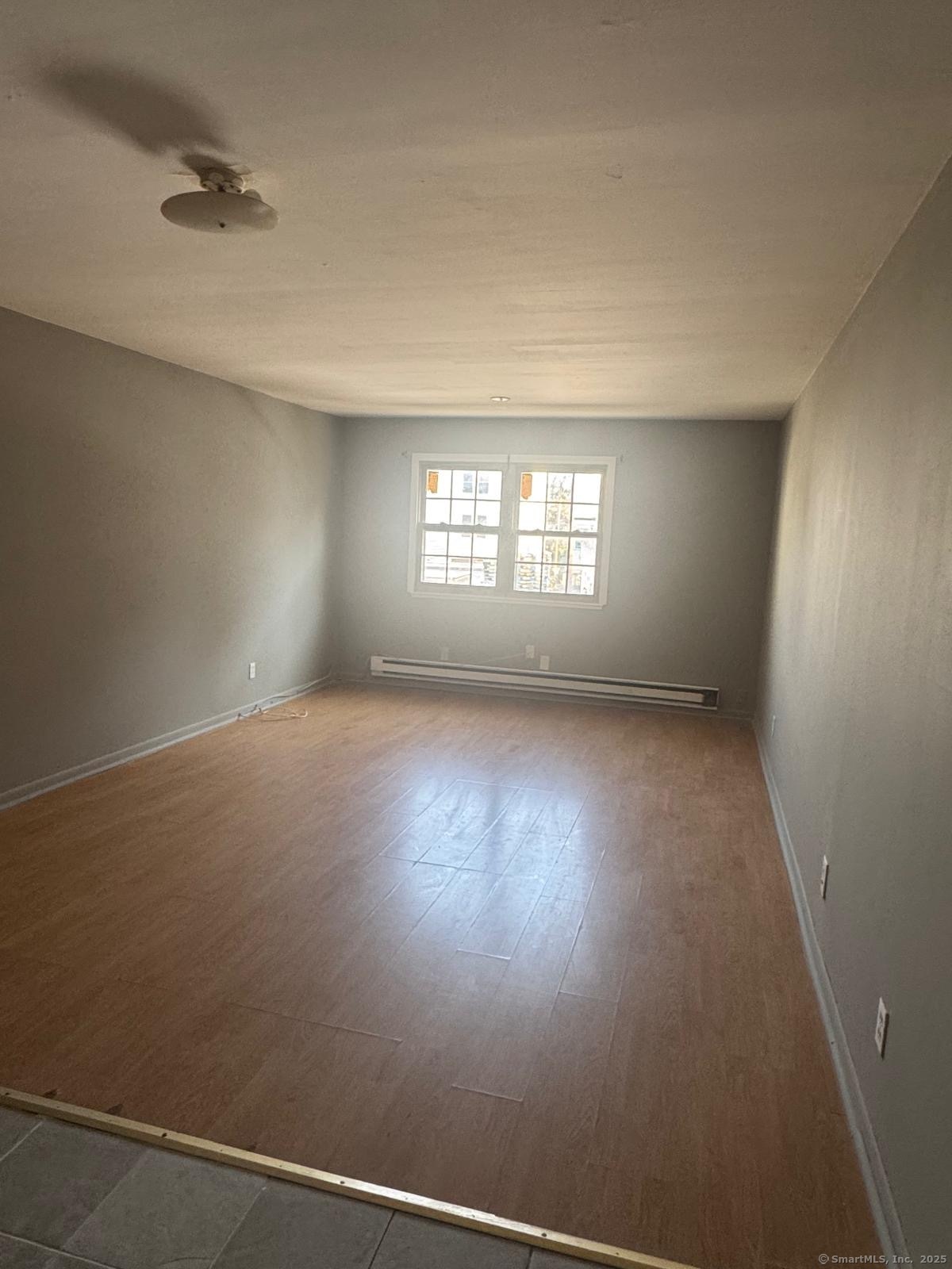 240 Oak Street, Unit 3 Bridgeport, CT 06604 - Photo 5 of 8 an empty room with windows
