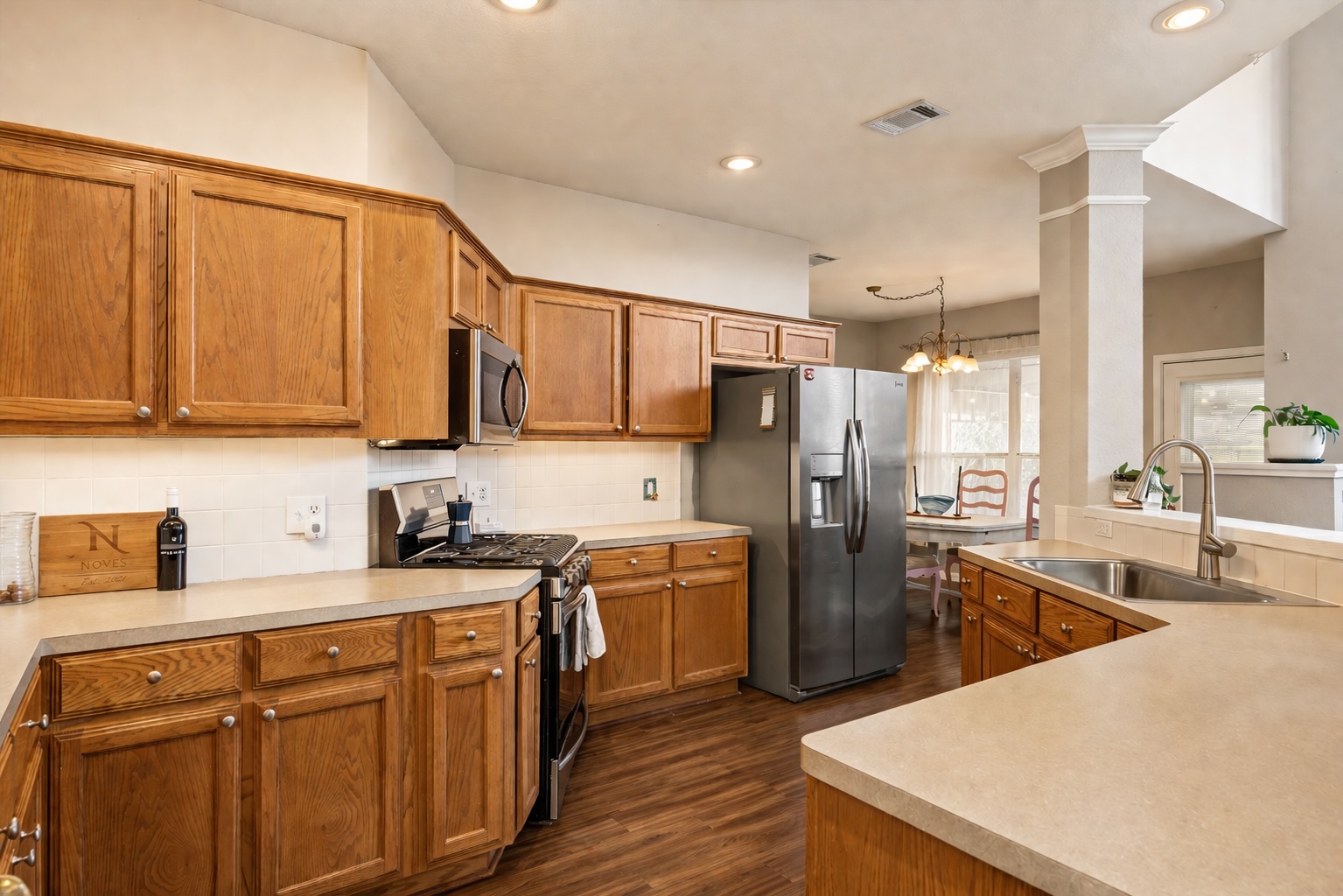 122 Summers Green Georgetown, TX 78633 - Photo 11 of 31 a kitchen with stainless steel appliances granite countertop a sink stove and refrigerator
