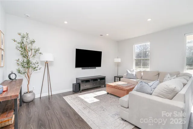 a living room with furniture fireplace and flat screen tv