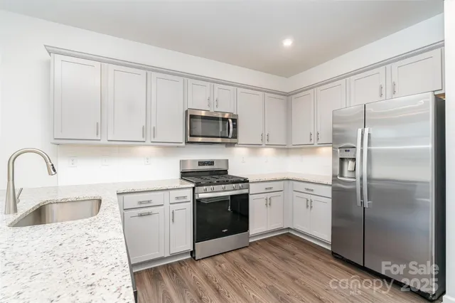 a kitchen with a sink stove and refrigerator