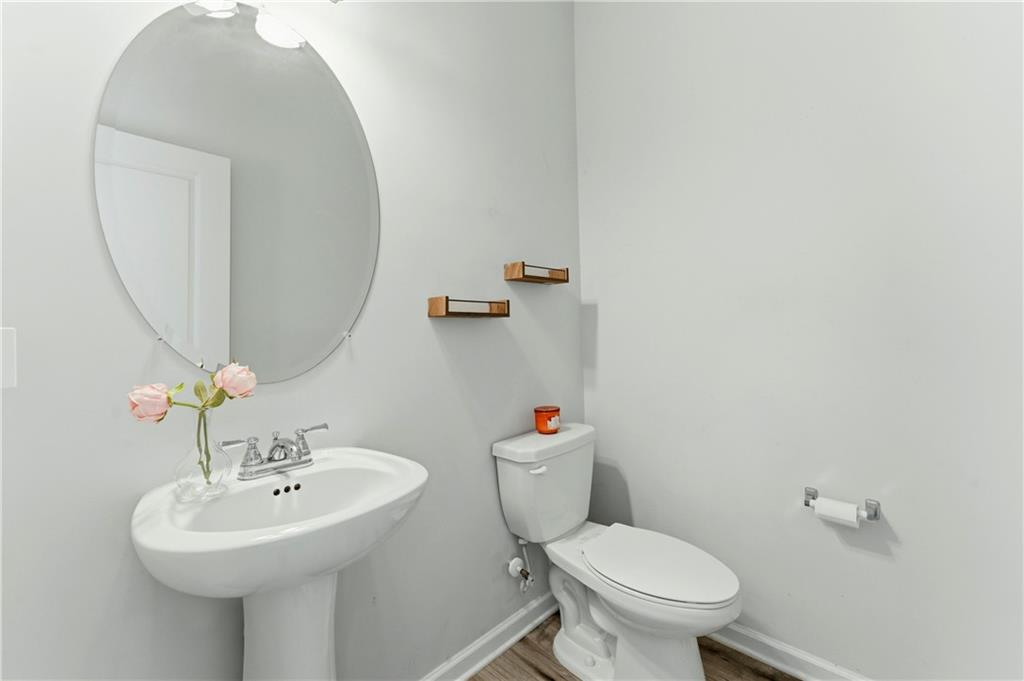 7492 Knoll Hollow Road Lithonia, GA 30058 - Photo 13 of 30 a bathroom with a sink mirror and toilet