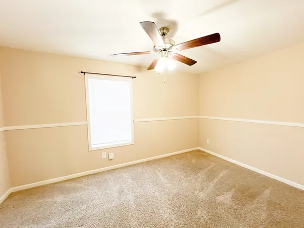 a bathroom with a granite countertop sink toilet a large mirror a shower and a bathtub