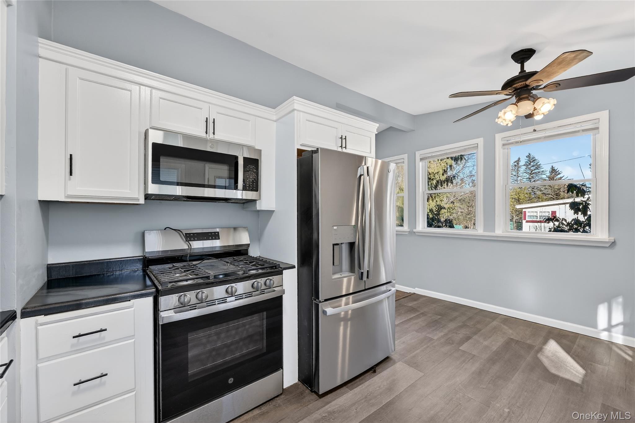2 The Curve Road Rock Hill, NY 12775 - Photo 12 of 31 a kitchen with stainless steel appliances white cabinets a stove a sink and a refrigerator
