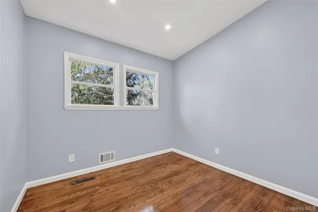 a view of room with wooden floor and window