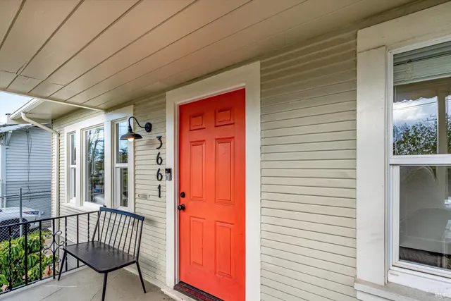 a view of a balcony with a potted plant and stairs