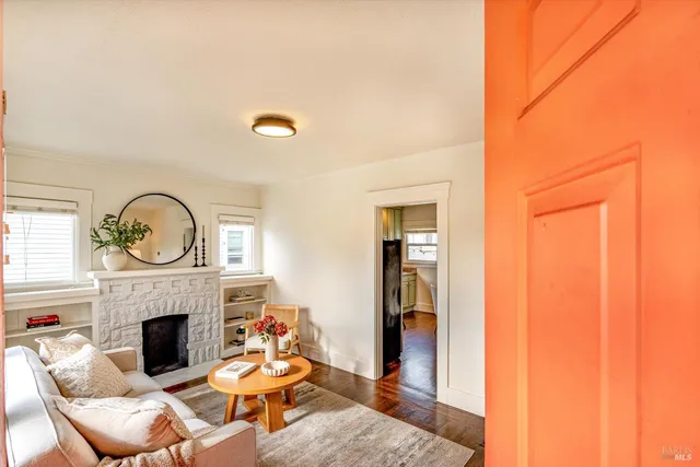 a living room with fireplace furniture and a fireplace