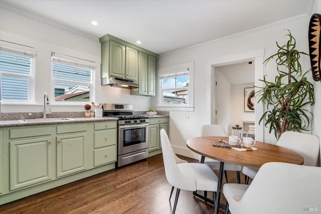a kitchen with stainless steel appliances granite countertop a refrigerator sink and stove