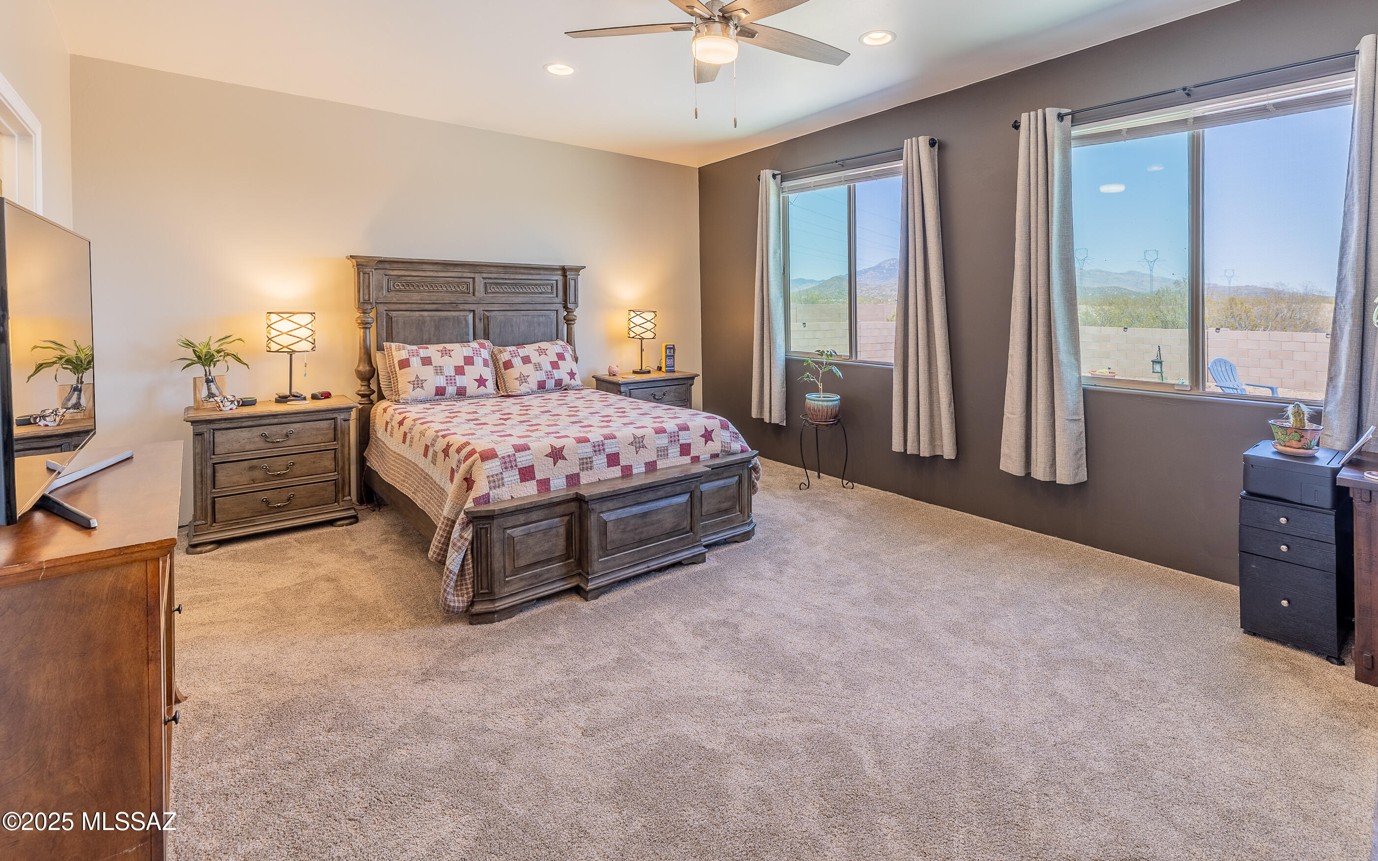12123 Creosote Valley Road Vail, AZ 85641 - Photo 16 of 46 a spacious bedroom with a bed and a chandelier