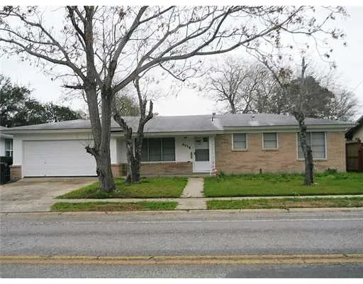 a front view of a house with a yard garage and outdoor seating