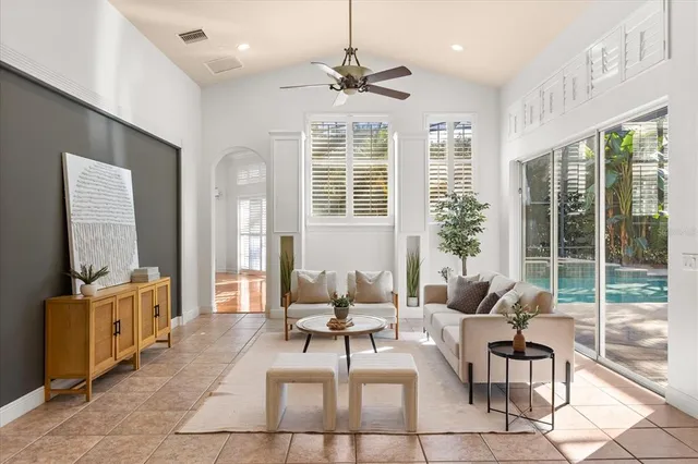 a spacious bedroom with a bed and a potted plant