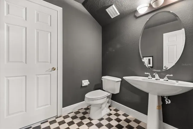 a view of a patio with couches table and chairs and potted plants