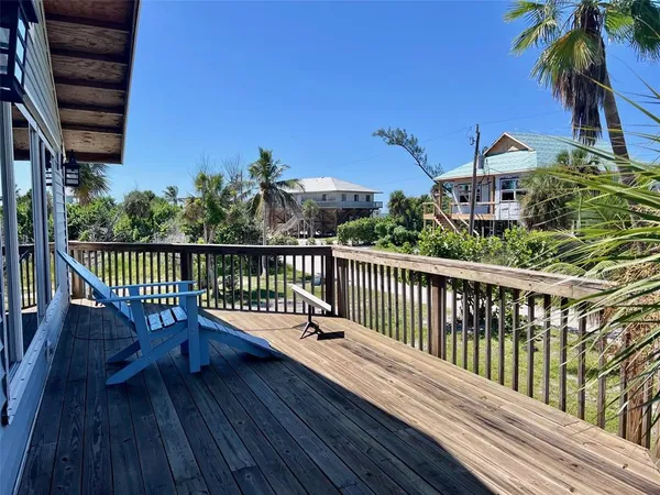 a view of a patio with table and chairs and wooden floor
