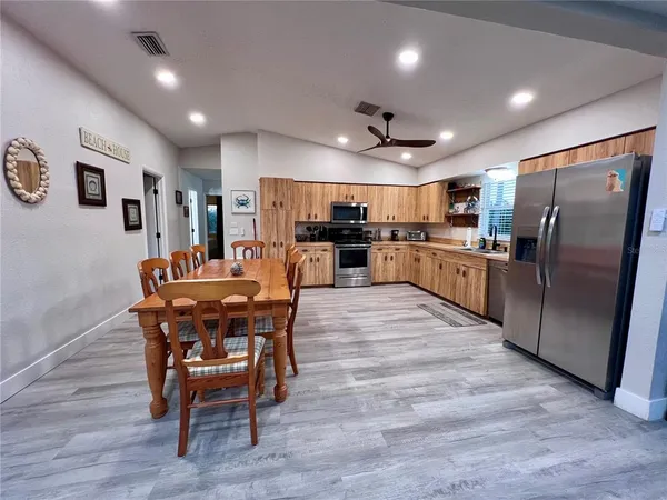 a spacious bedroom with a bed and a chandelier