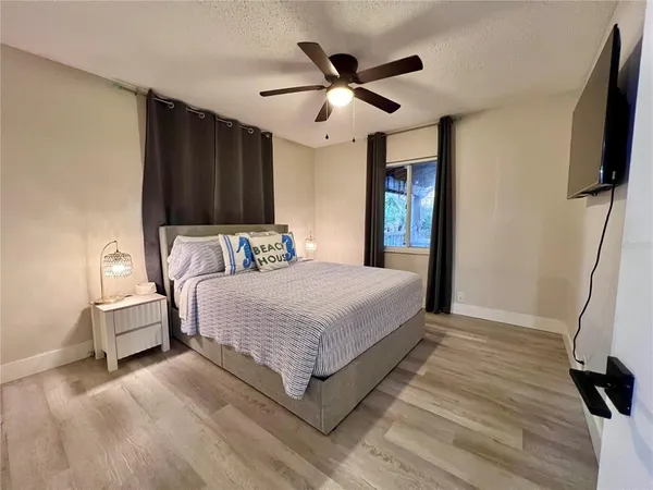 a bedroom with a bed and a large window