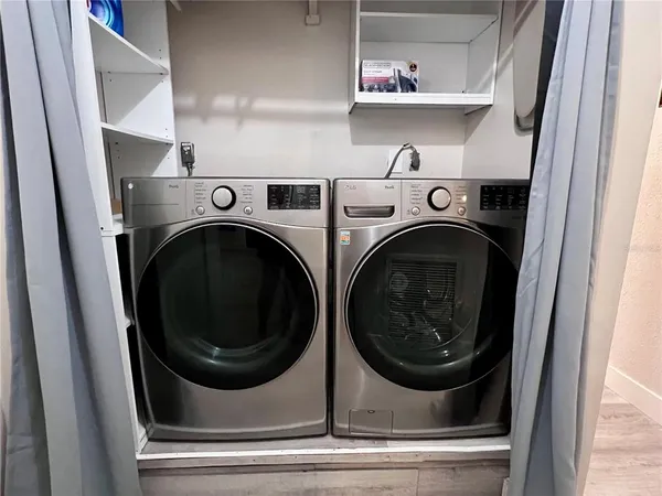 a view of a hallway with wooden floor and windows