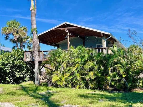 an aerial view of a house with a yard and lake view
