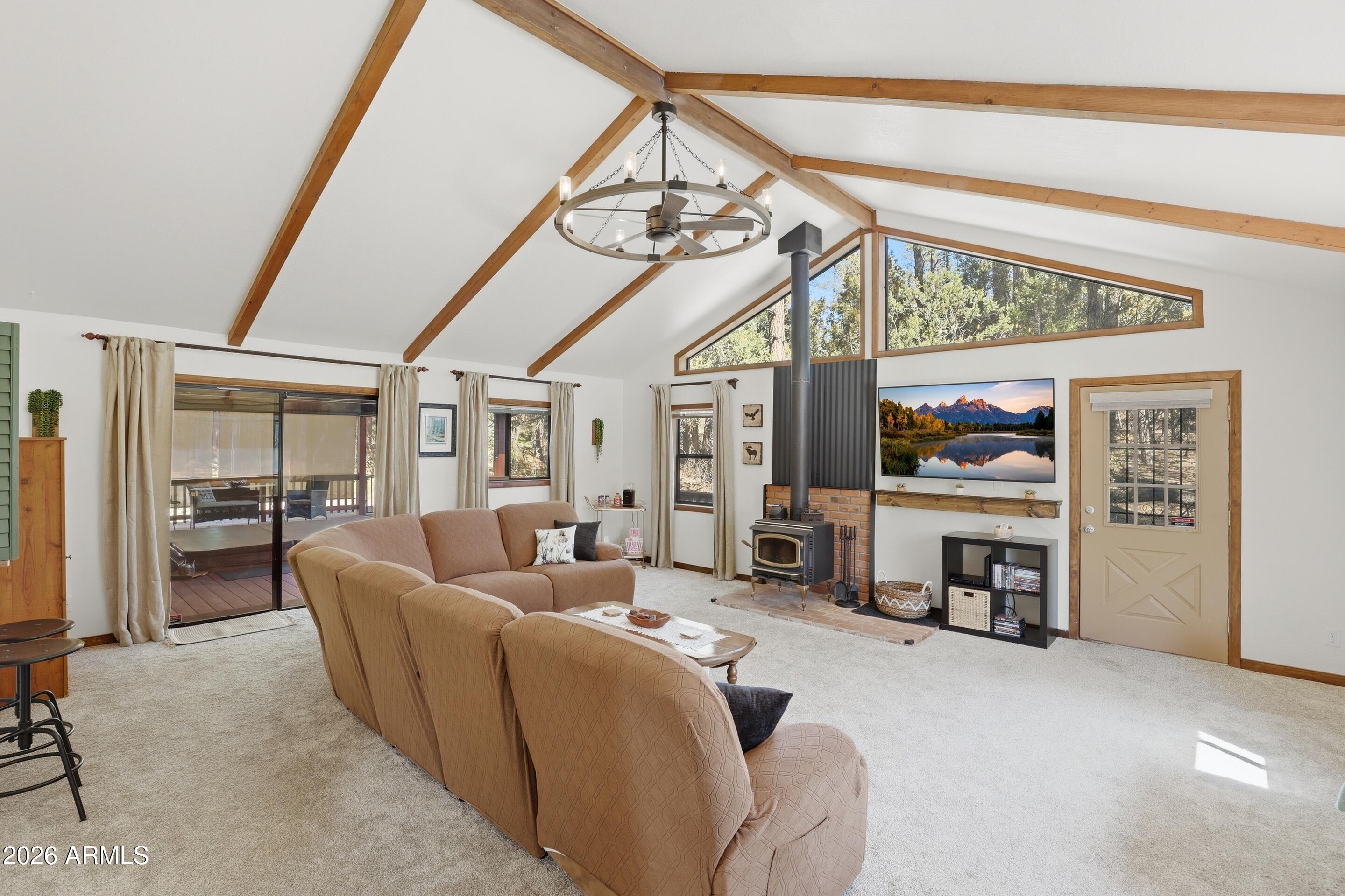 6740 Ridge Road Pine, AZ 85544 - Photo 7 of 35 a living room with furniture a fireplace and gym equipment
