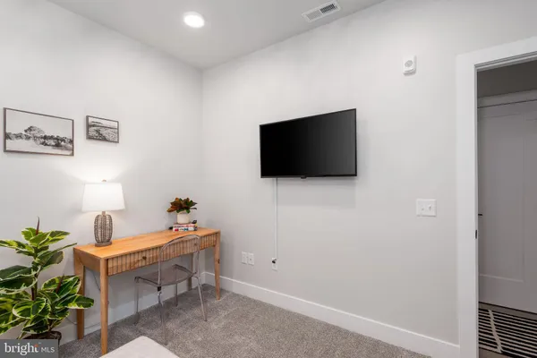 a bedroom with a bed and a potted plant