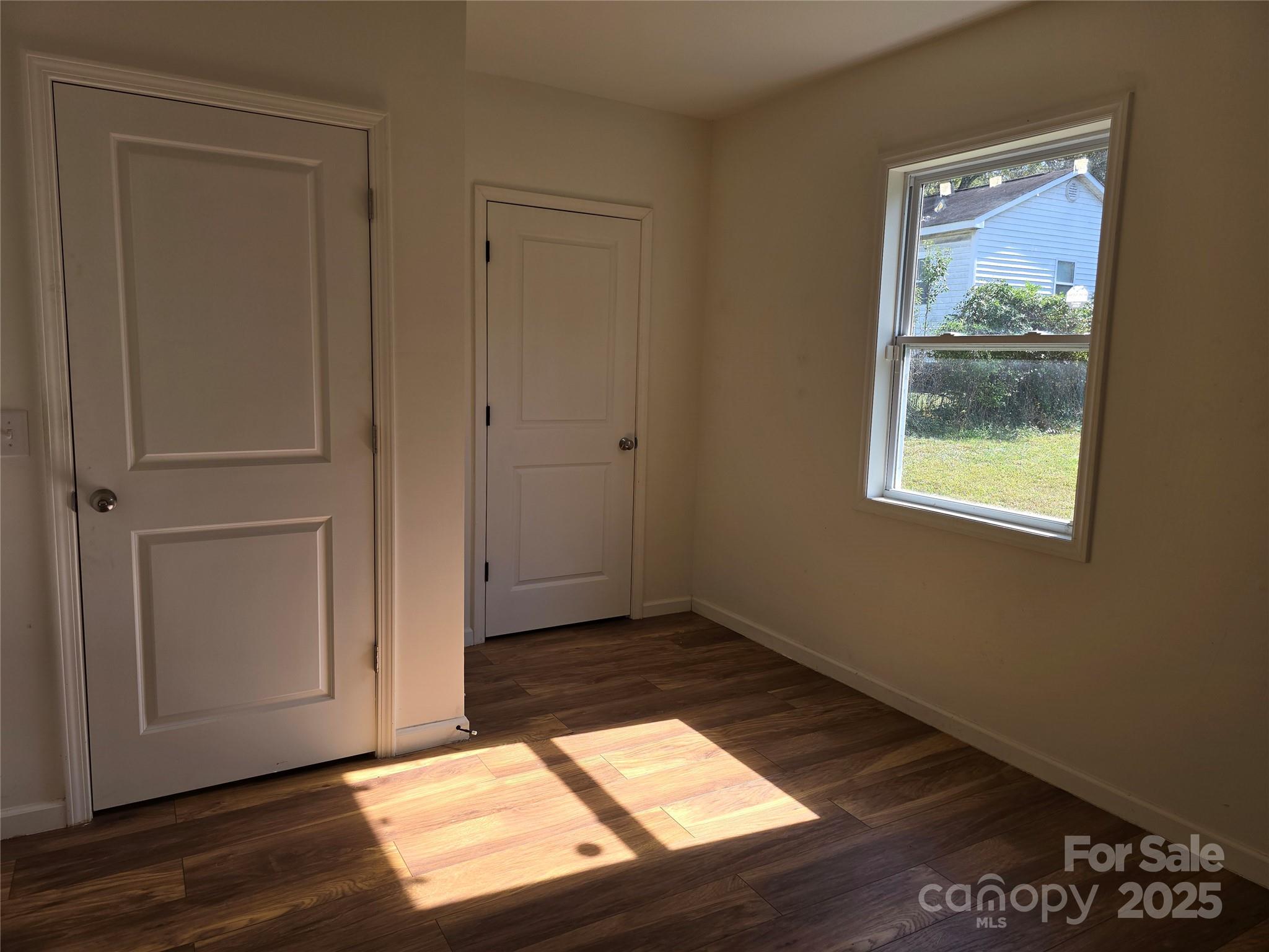 169 East Lacy Street Chester, SC 29706 - Photo 11 of 17 an empty room with wooden floor closet and windows