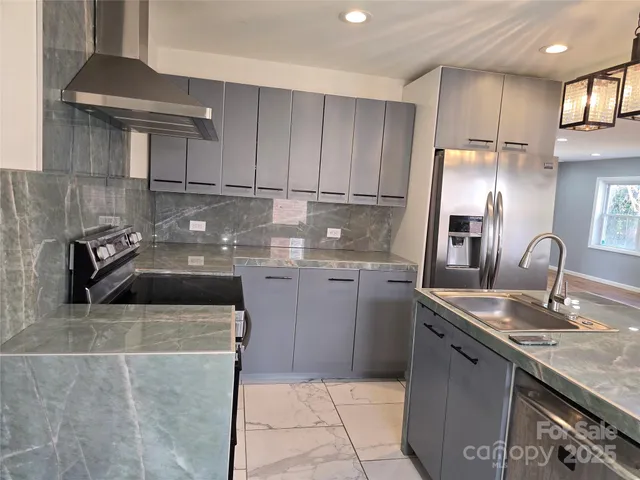 a kitchen with a sink stove and cabinets