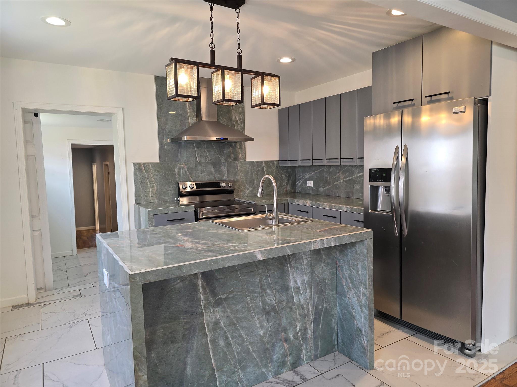 169 East Lacy Street Chester, SC 29706 - Photo 5 of 17 a kitchen with stainless steel appliances granite countertop a sink a refrigerator and a stove