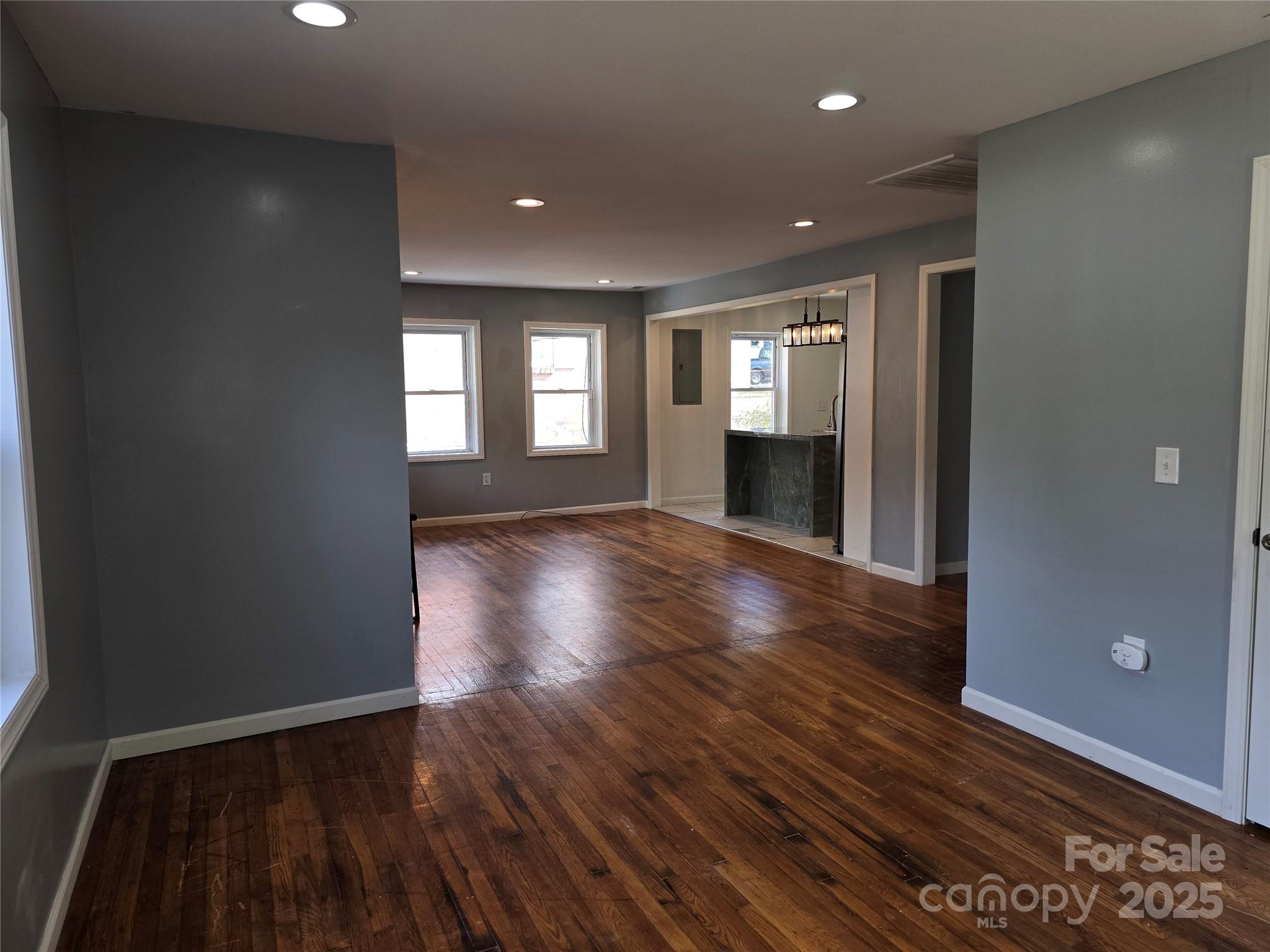 169 East Lacy Street Chester, SC 29706 - Photo 6 of 17 an empty room with wooden floor and windows