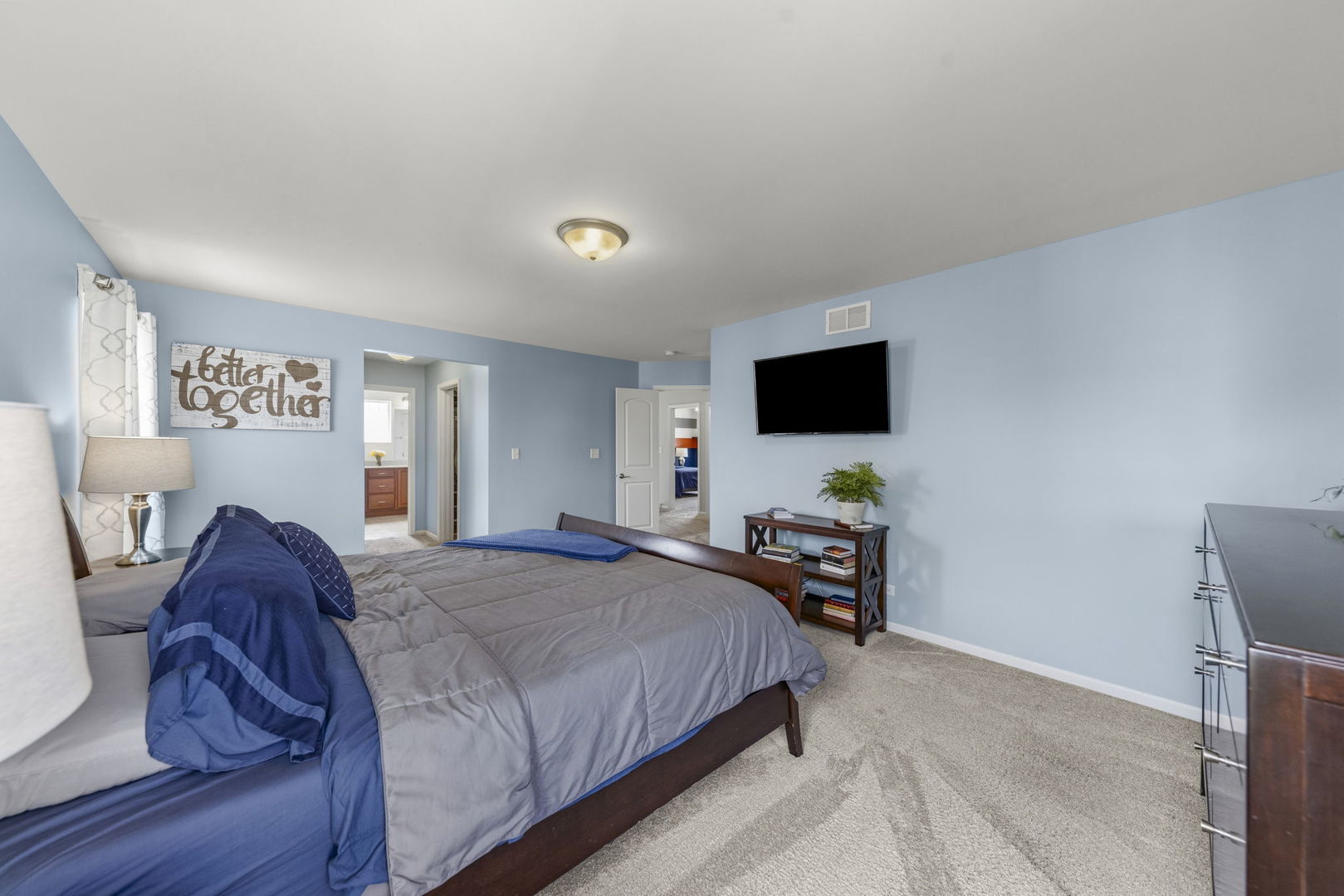 3306 Rumsford Boulevard Elgin, IL 60124 - Photo 16 of 29 a bedroom with a bed and a flat tv screen on dresser