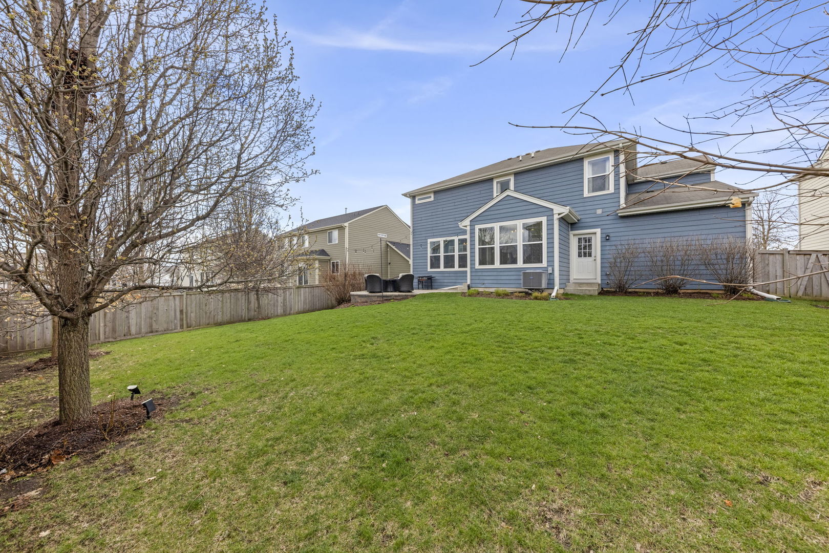 3306 Rumsford Boulevard Elgin, IL 60124 - Photo 28 of 29 a front view of a house with a yard and trees