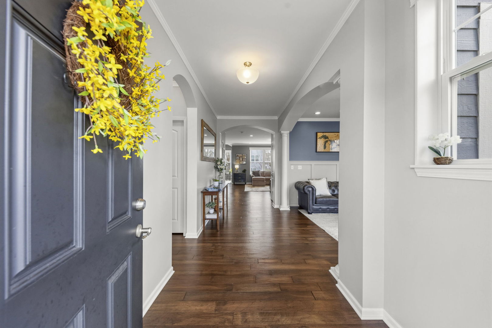 3306 Rumsford Boulevard Elgin, IL 60124 - Photo 3 of 29 a hallway with a dining table and chandelier