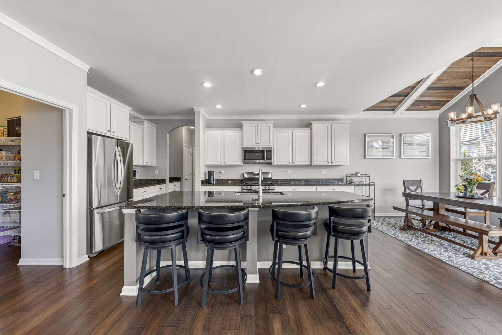 3306 Rumsford Boulevard Elgin, IL 60124 - Photo 7 of 29 a kitchen with stainless steel appliances a dining table chairs and wooden floor