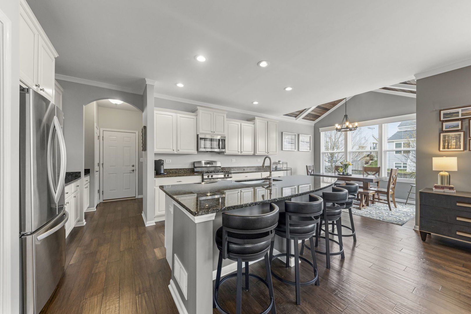 3306 Rumsford Boulevard Elgin, IL 60124 - Photo 8 of 29 a kitchen with stainless steel appliances a dining table chairs and wooden floor