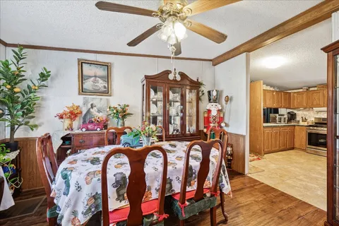 a view of a dining room with furniture and chandelier