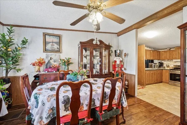 a view of a dining room with furniture and chandelier