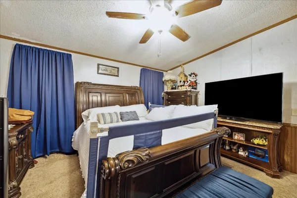 a bedroom with furniture and a flat screen tv