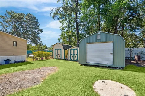 a front view of house with yard and trees