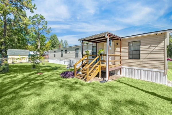 a view of a house with a backyard