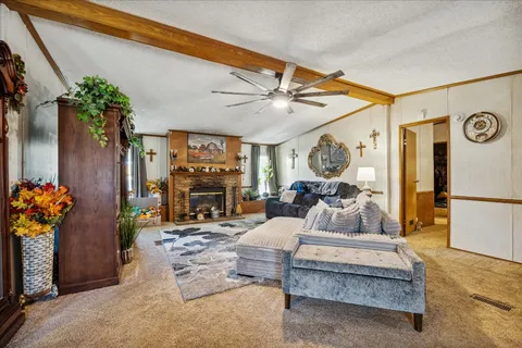 a living room with furniture a fireplace and a chandelier