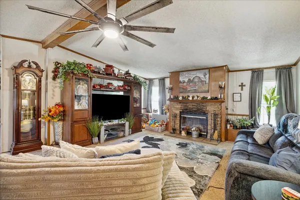 a living room with furniture flat screen tv and a fireplace