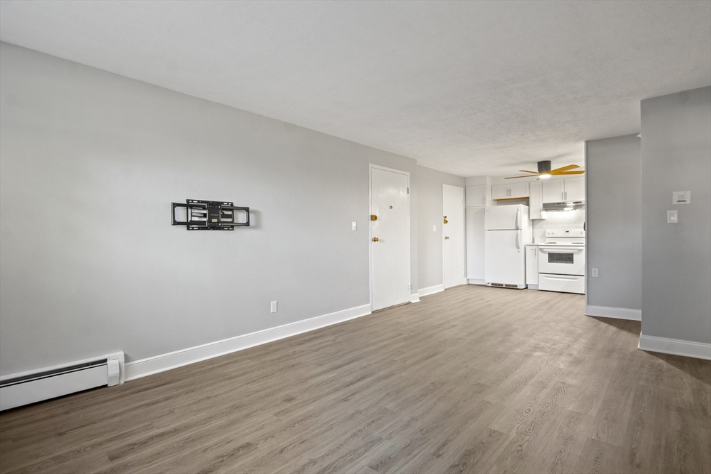 1105 Lexington Street, Unit 102 Waltham, MA 02452 - Photo 11 of 41 a view of empty room with wooden floor