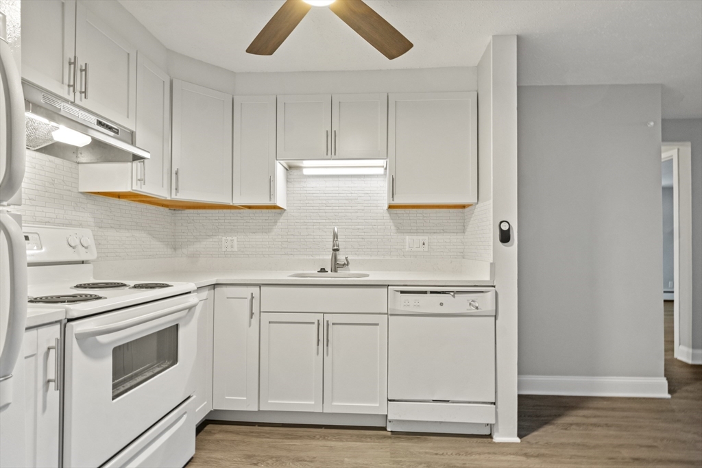 1105 Lexington Street, Unit 102 Waltham, MA 02452 - Photo 17 of 41 a kitchen with white cabinets and white appliances