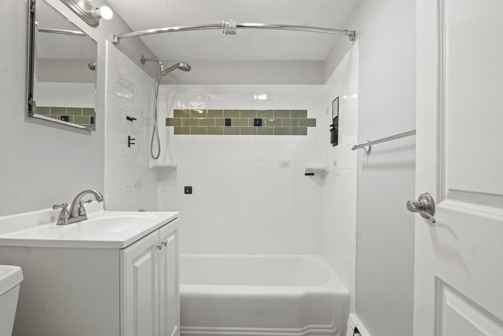 1105 Lexington Street, Unit 102 Waltham, MA 02452 - Photo 26 of 41 a bathroom with a bathtub and a sink